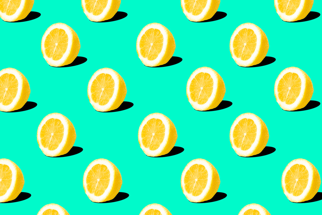 A pattern of sliced yellow lemons on a turquoise background.